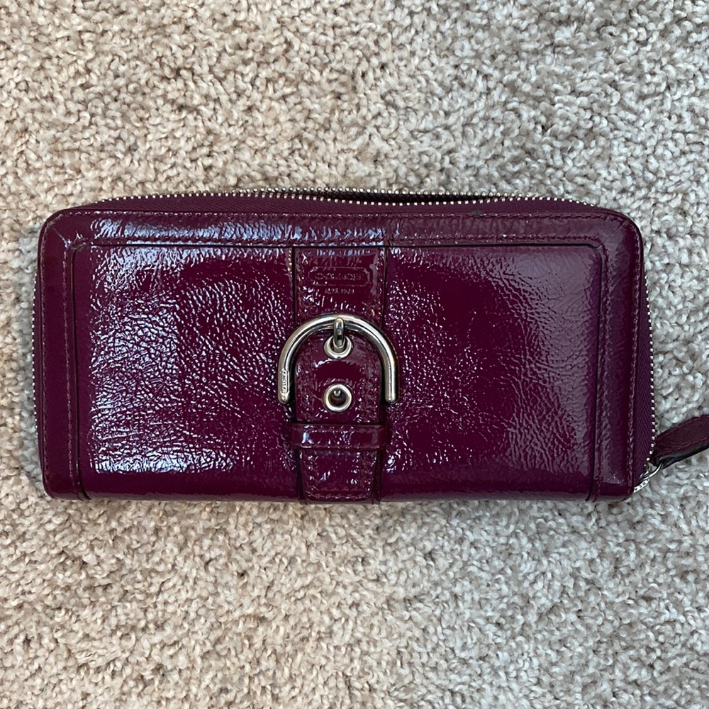 Coach purple buckle zip wallet.  Outside looks amazing, inside has some wear